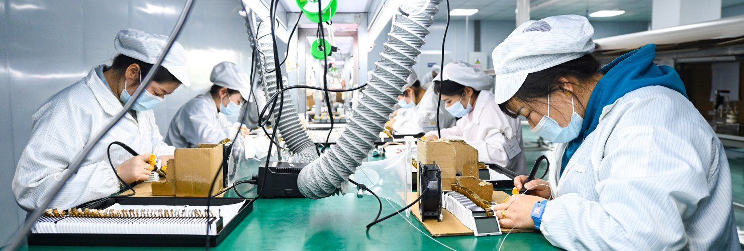 Workers make liquid crystal displays and modules on the production line at a semiconductor production workshop in China