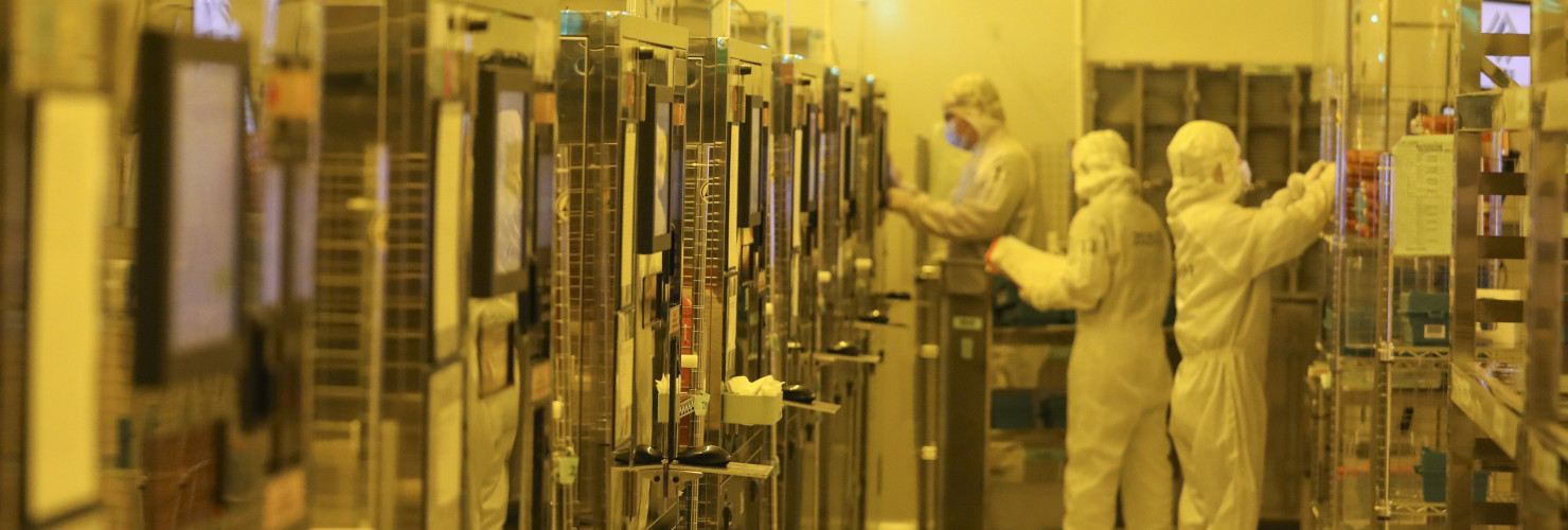 Workers process chips at a workshop of an optoelectronic technology company in Huai 'an city, Jiangsu province, May 11, 2024.