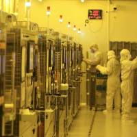 Workers process chips at a workshop of an optoelectronic technology company in Huai 'an city, Jiangsu province, May 11, 2024.