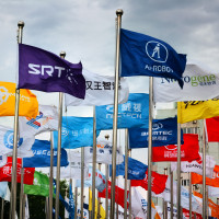 Factory flags of famous Chinese enterprises flutter in the wind under the blue sky in front of the square of the permanent site of the Zhongguancun Forum in Beijing, China, May 14, 2024.